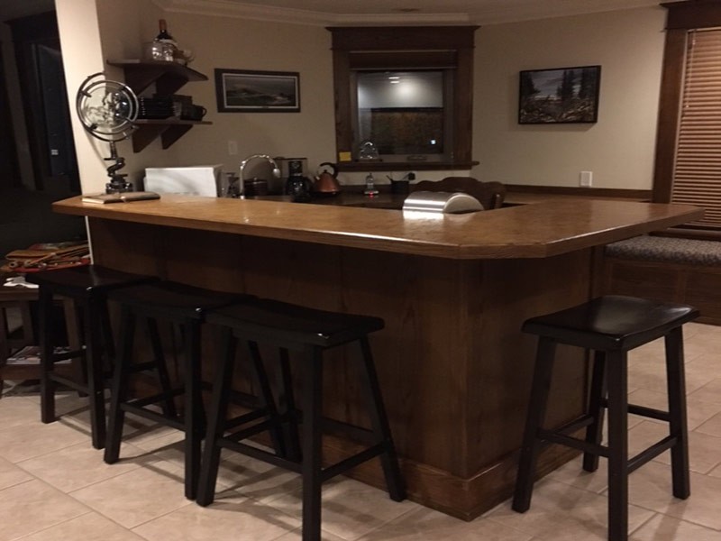 A Large Wooden Table With Wooden Stools