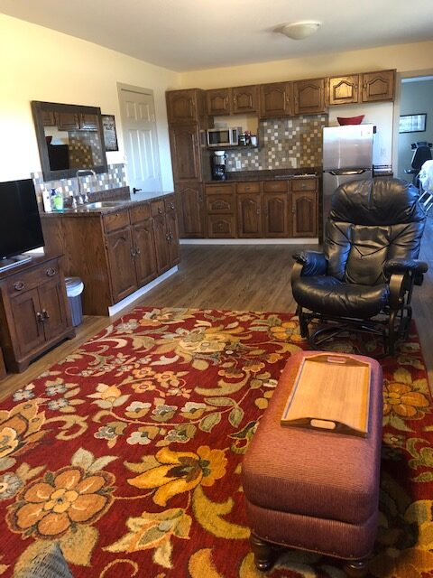 A Kitchen With a Red Color Floral Carpet