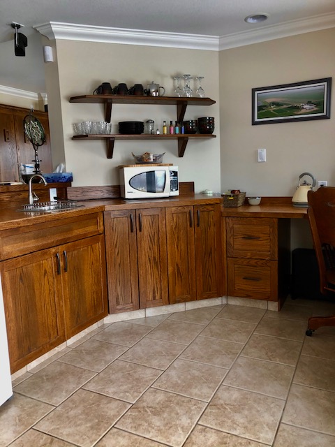 A Kitchen With a U Shaped Wooden Cupboards