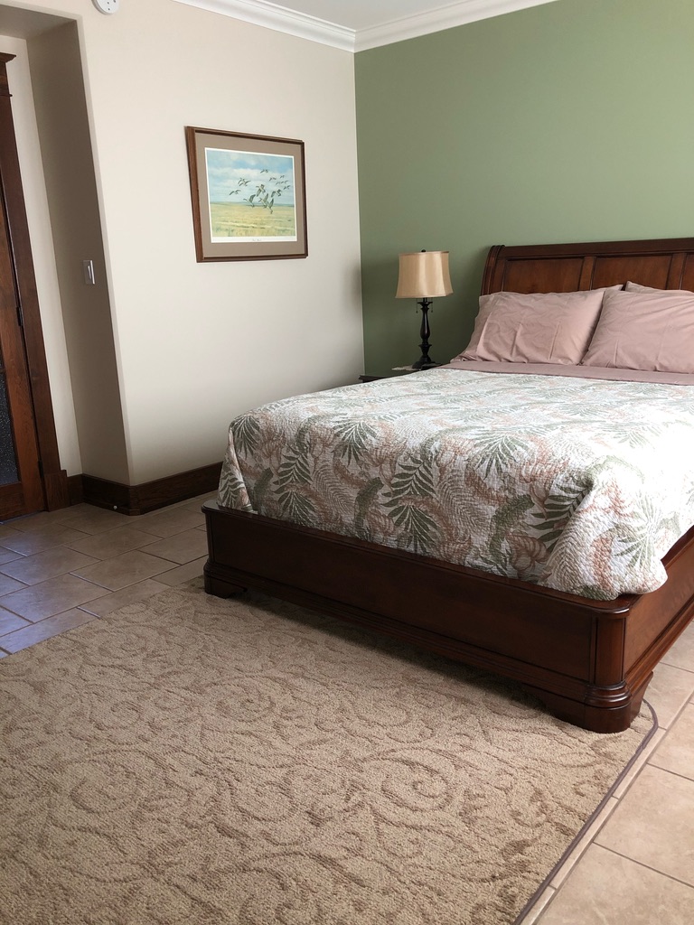 A Bed With a Pink and White Bed Covers